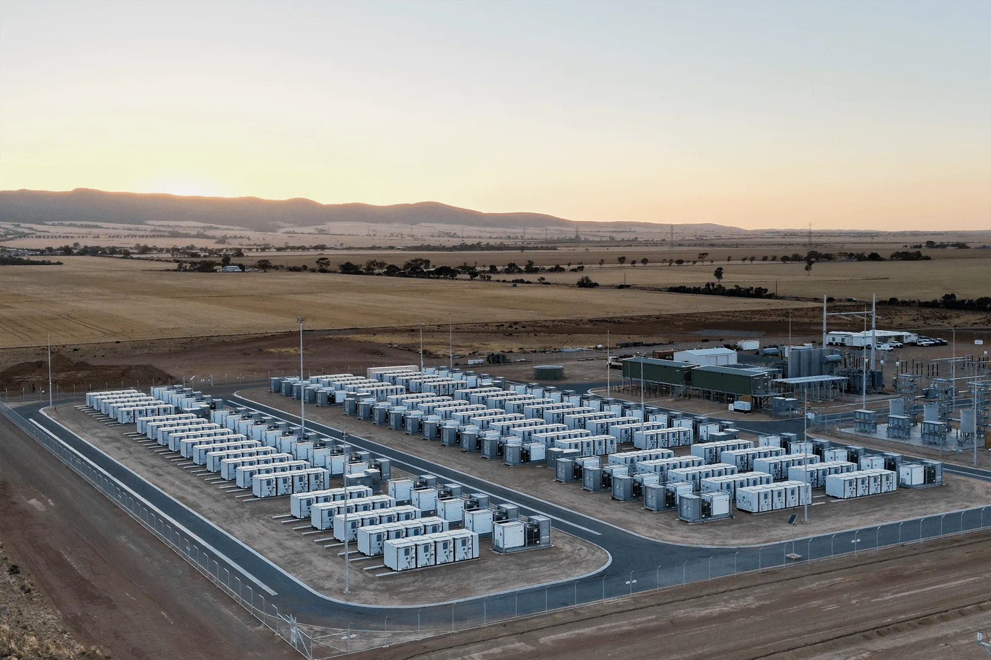 Aerial view of a battery energy storage facility in a desert landscape.