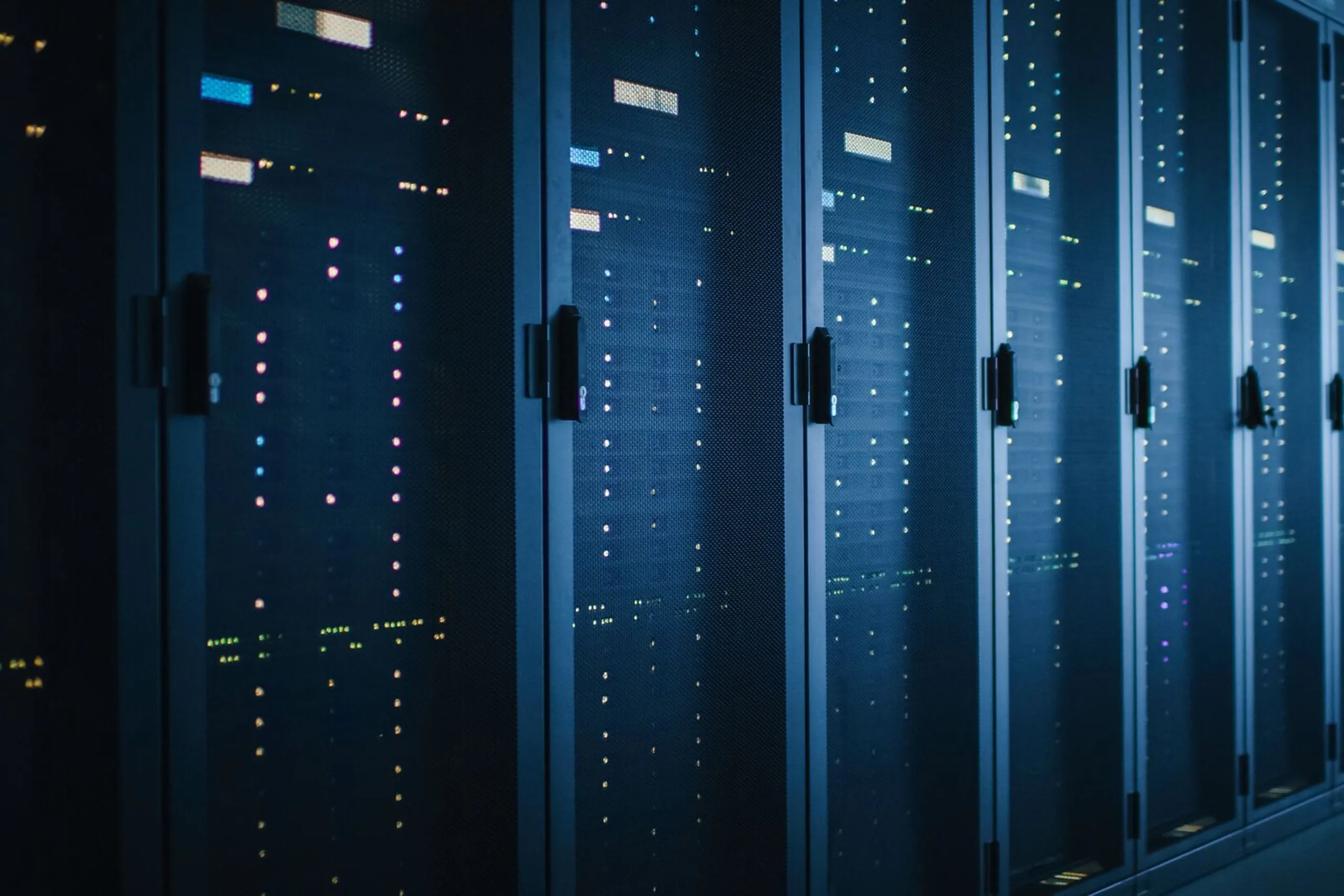Rows of illuminated server racks in a data center.